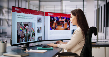 Woman Looking At News In Online Newspaper