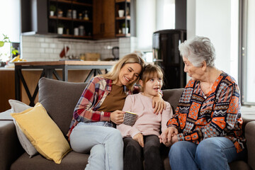Generational bonding, grandmother, daughter, and grandchild sharing stories on a cozy afternoon