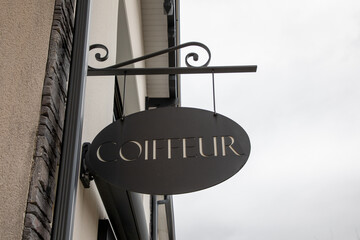 coiffeur french text hairstyle translated into hairdresser barber shop on sign wall facade entrance