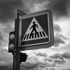 Black and White Crosswalk Road Sign with Dark Clouds in the Background - 749199908