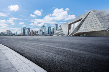 Empty asphalt road and modern commercial buildings background
