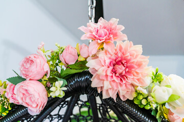 Obraz premium Composition of artificial flowers on a cocoon, armchair.