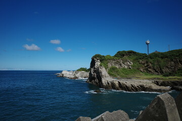 Coastal Serenity: Seaside Bliss with Beachside Rocks and Charming Homes in Nature's Embrace