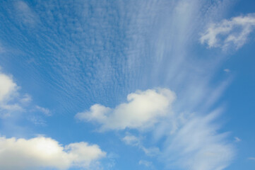 Spindrift clouds. Cumulus clouds against a blue sky. No focus.