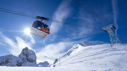 Fototapeta na wymiar Sunlit Snowy Peaks and Ski Cabin: A View from the Italian Alps