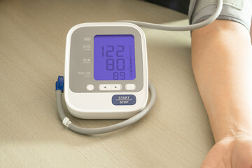 man check blood pressure monitor and heart rate monitor with digital pressure gauge. Health care and Medical concept