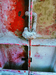 A rusty metal object with a bolt on it. The bolt is in the middle of the object and is surrounded by rust