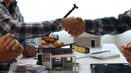 Closeup of hands engineer and architect team discussed about construction and architectural drawings works.