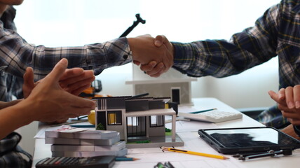 Closeup of hands engineer and architect team discussed about construction and architectural drawings works.