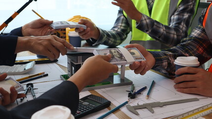 Closeup of hands engineer and architect team discussed about construction and architectural drawings works.