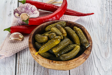 Marinated small cucumbers in the bowl