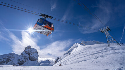 Sunlit Snowy Peaks and Cable Car: A View from the Italian Alps