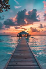 sunrise island maldives over the ocean and wooden pier in sunrise
