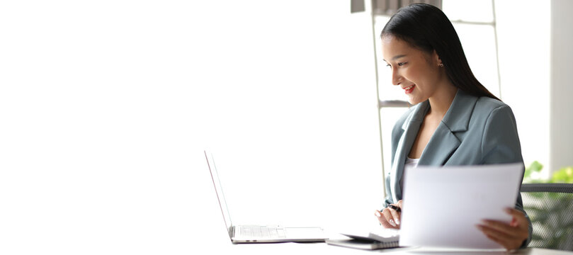 Businesswoman working with documents is analyzing financial data statistically, calculating income and expenses, managing budgets and planning finances.