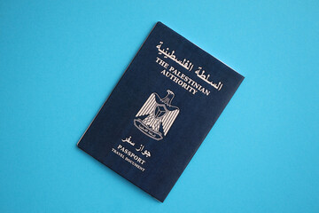 Blue Palestinian Authority passport on blue background close up. Tourism and citizenship concept