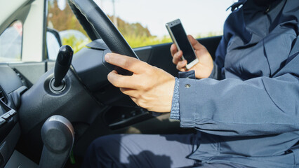 スマホを持ちながら運転する男性　イメージ