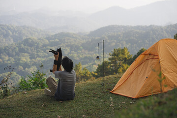 landscape and travel concept with solo freelancer man relax and play with cat and see sunset with...