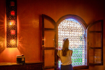 Girl looking out the window in Marrakesh