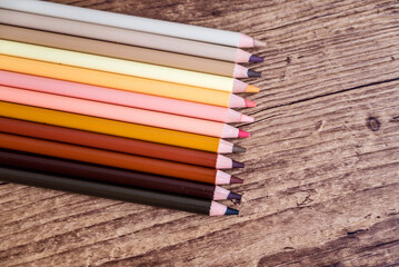 Pastel pencils with copy space on wooden background 
