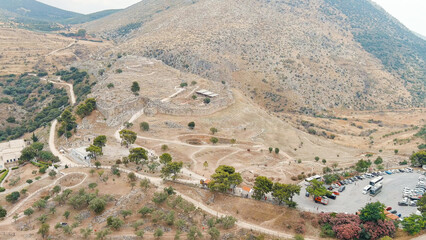 Fototapeta na wymiar Mycenae, Greece. Excavation site: Greek settlement of the 12th century BC. e. with the ruins of the acropolis, palace and tombs, Aerial View