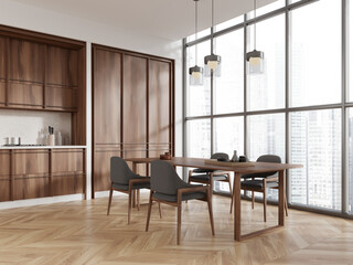 Stylish home kitchen interior with cooking and dining table, panoramic window