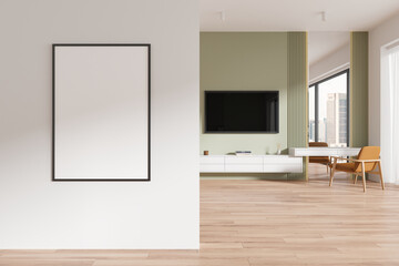 White and green living room with TV and poster