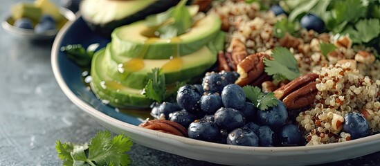 A bowl filled with fresh blueberries, ripe avocado slices, and crunchy nuts, creating a nutritious and vibrant salad with a maple syrup lime dressing and quinoa base.