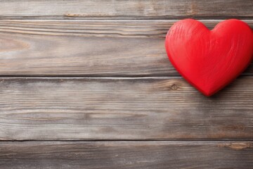 Fototapeta premium A vibrant red heart rests on rustic wooden planks, symbolizing love and Valentine's Day celebration. Red Heart on Vintage Wood for Valentine's Day