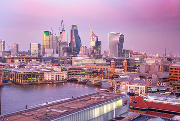 Modern London skyline with shard building on horizon at sunset on cloudy day