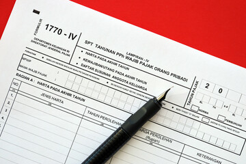 Indonesian tax form 1770-4 Individual Income Tax Return and pen on table close up