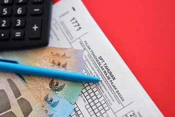 Indonesian tax form 1771 corporate taxpayers annual income tax return with pen lies on accountant...