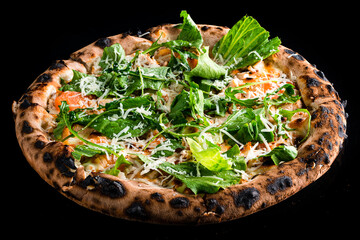 Italian food pizza with chicken, cheese, tomatoes, arugula, lettuce and spices isolated on black.
