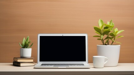 Desk with mockup blank screen laptop, books and plant,  minimal background