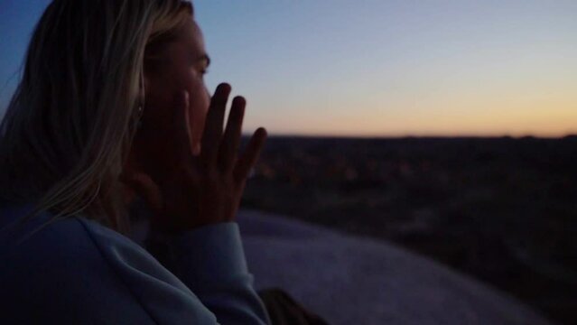 beautiful girl shaman plays the jew's harp at sunset