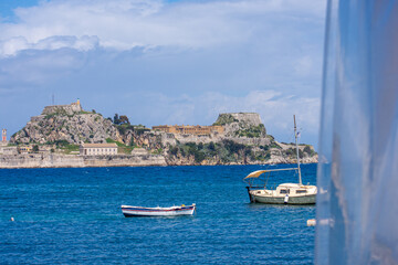 2 small boat with corfu old fortress in background