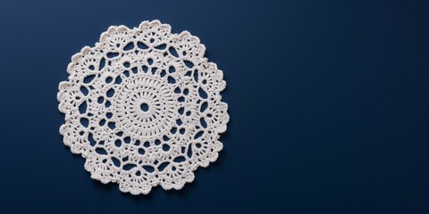 White crochet napkin on a blue background.