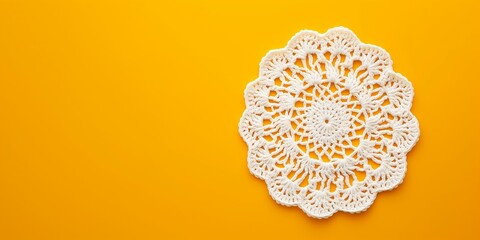 White crochet doily on a yellow background. - obrazy, fototapety, plakaty