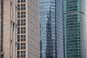 Fototapeta na wymiar The city of Shanghai has many tall towers, as well as shapes with different architecture, photography of the pattern of the structure and the icons of the windows of different towers in this city, Cn