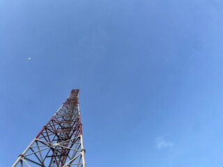 Communication tower against crystal clear blue sky background