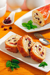 Swiss roll with cheese and cranberries.