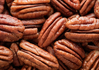Raw peeled brown pecan nuts top view macro background.Top view.