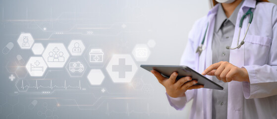 Medical technology concept. Doctor in white coat using digital tablet with medical icons network connection