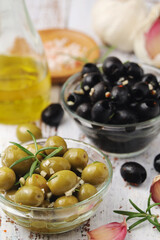Black and green olives in glass bowls