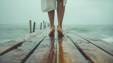 Rolgordijnen walking barefoot on the pier © UsamaR