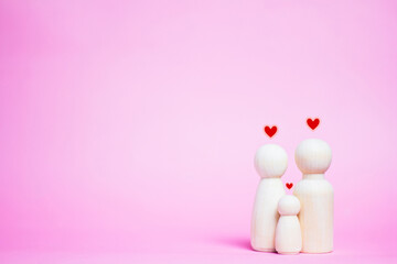 Family wooden puppets on pink background Life insurance ideas for future financial security and...