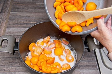 Apricot halves being added to the saucepan