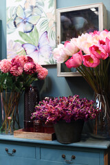 Fototapeta na wymiar Lots of flowers in flowerpots on the shelf