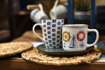 Cups with nautical pattern on table