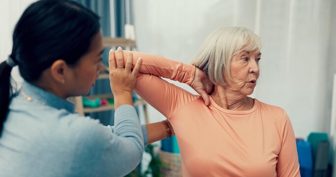 Physiotherapy, stretching and senior woman in consultation for support, exam and helping with shoulder or muscle. Doctor, physiotherapist or nurse and elderly patient arm or elbow, check and service