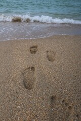 Fototapeta na wymiar The footprint on the beach tells a silent story of wanderlust and leisure. It's an imprint left behind by an adventurer, a dreamer, or perhaps someone seeking solace in the soothing embrace of the sea